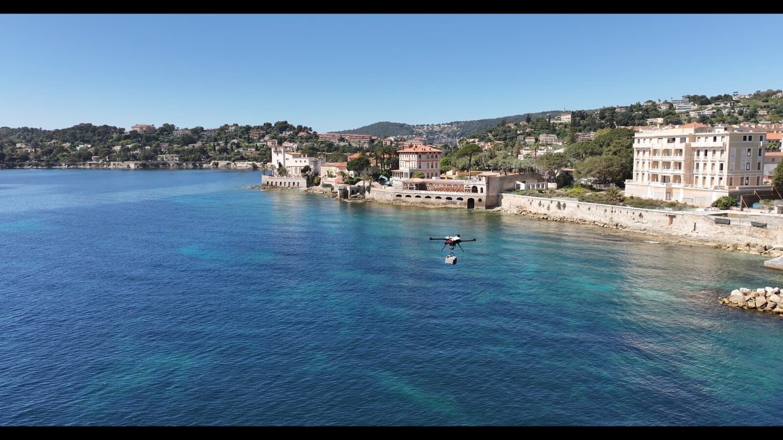 Drone crossing the bay with a parcel, Cap Ferrat
